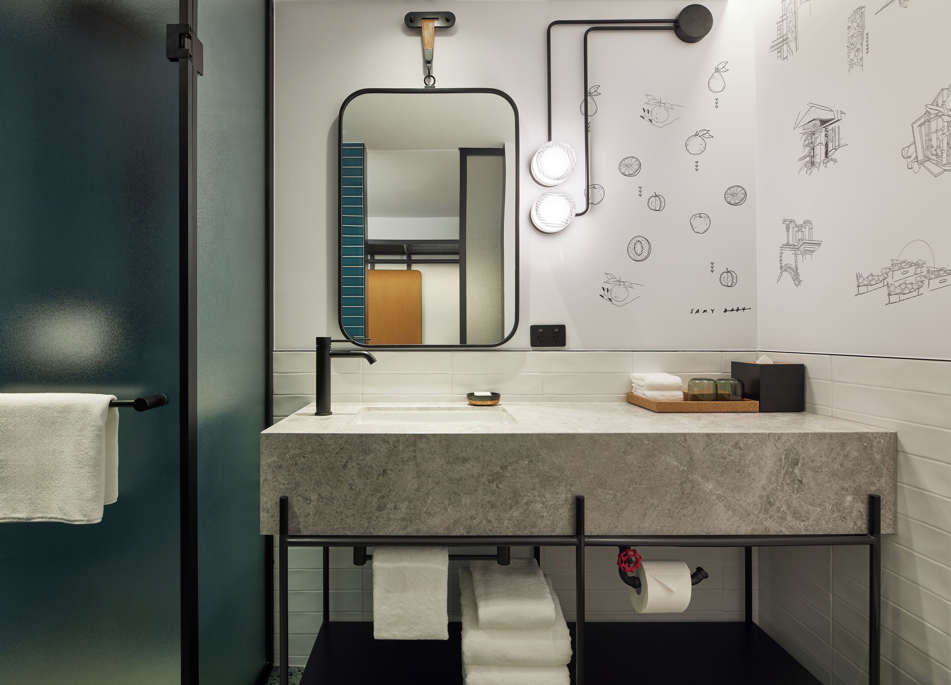 A modern bathroom with a large mirror, a sink, and a towel rack.