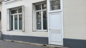 A building facade with two windows and a door.