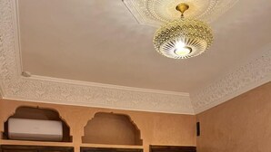A room with a patterned floor, a bed, a wardrobe, and a mirror. - Dar Hilana Locanda Boutique Collection (Marrakech)
