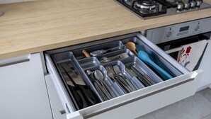 A kitchen drawer with utensils and cookware. - Downtown Apt - Top Location, Metro nearby (Warszawa)