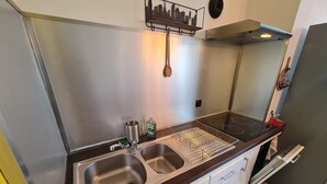 A modern kitchen with stainless steel appliances, a double sink, and a built-in oven.