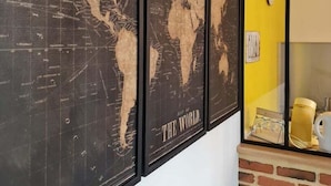 A wall with three framed world maps titled 'THE WORLD.'