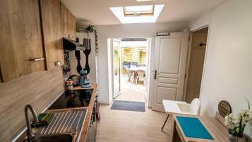 A compact kitchen with a skylight, a sink, and a small dining area.