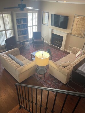 Smart TV, fireplace, books, computer monitors