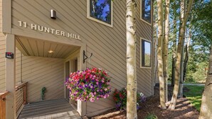 A building with the sign '11 Hunter Hill' and a hanging flower basket.