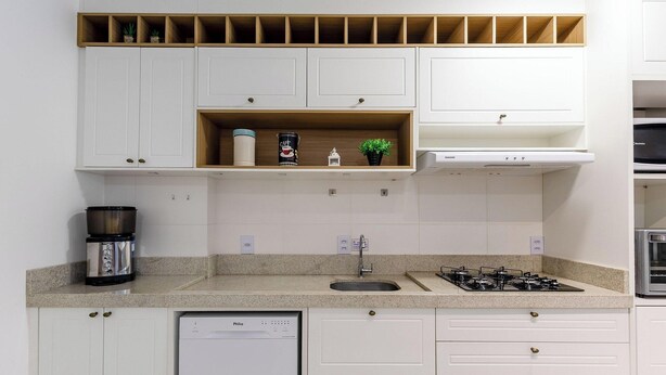 A modern kitchen with white cabinets, a granite countertop, a coffee maker, a gas stove, and a dishwasher. - Modern apt With Pool Near the Beach Avr0203 (Penha)