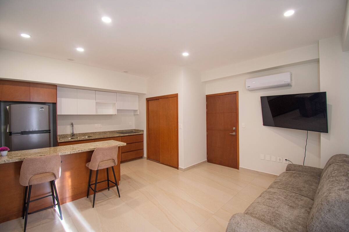 Comfort Apartment | Living area | 50-inch flat-screen TV with cable channels