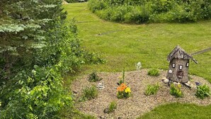 A serene garden with a wooden birdhouse and a small pond.