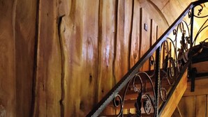 A wooden staircase with ornate metal railings.