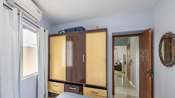 A bedroom with a wardrobe, a bed, and a door leading to another room. - Beachfront Apartment in BC Great Location Eit302 (Balneário Camboriú)