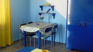 A dining area with a table, chairs, and a blue cabinet. - Apartments A&N Pakoštane - Two Bedroom Apartment with Sea View (A2) (Pakoštane)