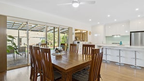 A modern kitchen with white cabinets, stainless steel appliances, and a bar area. - Jacks Corner - Moments to the beach, free wifi, pet friendly - wont be disapointed! (Normanville)