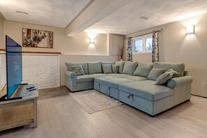 Smart TV, fireplace, books, computer monitors
