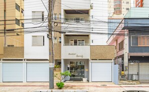 Un bâtiment à deux étages, avec une entrée au niveau du sol et un balcon bien visible.