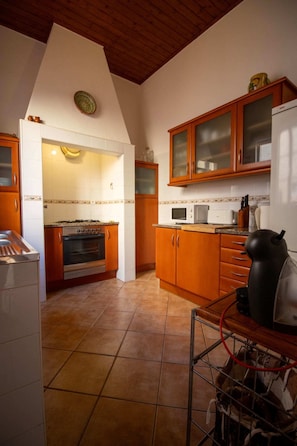 A kitchen with wooden cabinets, a microwave, and a stove.