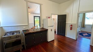 Una cocina compacta con estufa a gas, un fregadero y un refrigerador.