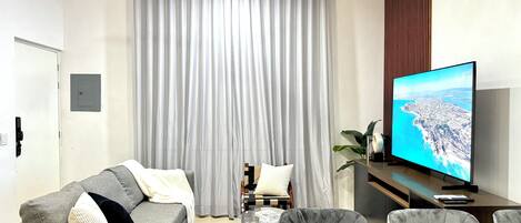 Deluxe Double Room | Living room | 65-inch LED TV with cable channels