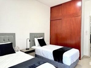 Premium bedding, down comforters, blackout drapes, iron/ironing board