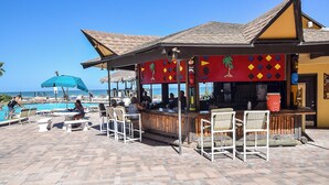A beachside bar with outdoor seating and a pool. -  Studio for 2 with Breathtaking View with A/C (Daytona Beach Shores)