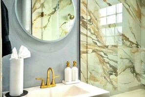 Shower, hair dryer, towels, shampoo