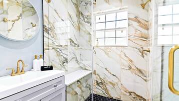 Shower, hair dryer, towels, shampoo