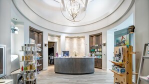 A modern, circular reception area with a central counter, surrounded by shelves with various products. - Enjoy views of the immaculate green from your screened lanai at Lakeside National - Golfside Escape (Bradenton)