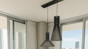 A modern dining area with a round table and six chairs, large windows with curtains, and two hanging pendant lights. - Miami Escape, 16th Floor – Near Hollywood Beach (Hollywood)