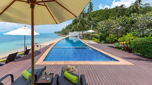 A poolside area with a view of the ocean, lounge chairs, and umbrellas. - Luxury Retreat with Private Chef & Concierge, Koh Samui Villa 1018 (Koh Samui)