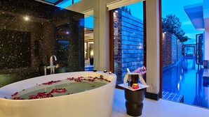 A modern bathroom with a large bathtub, a mirror, and a view of the outside. - Luxury Retreat with Private Chef & Concierge, Koh Samui Villa 1018 (Koh Samui)
