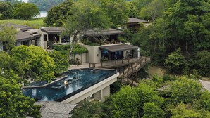 A resort with a large swimming pool, multiple buildings, and lush greenery. - Nekajui Peninsula Papagayo, a Ritz-Carlton Reserve Residence (Papagayo)
