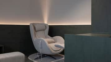 A modern chair with a high backrest and armrests, positioned on a textured rug.