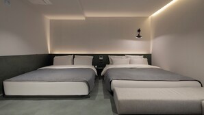 A modern hotel room with two single beds, a small bedside table, and a wall-mounted light fixture. - Anook Hotel Suwon Station (Suwon)