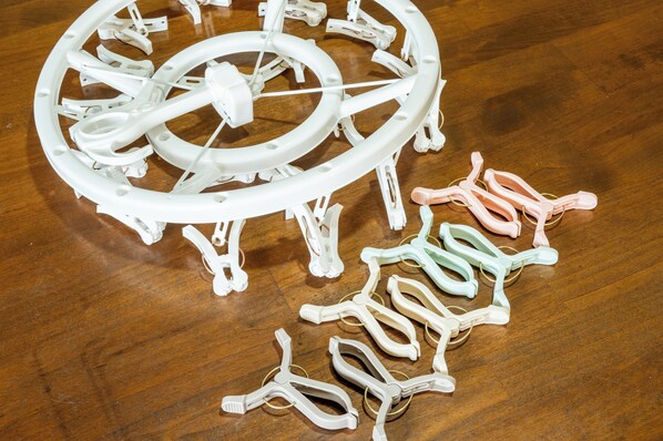 A model of a Ferris wheel with its components laid out on a wooden floor.