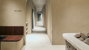 A hallway with a bench and a stone feature on the right. - TRAN.SCENDER HOTEL Yokohama (Yokohama)