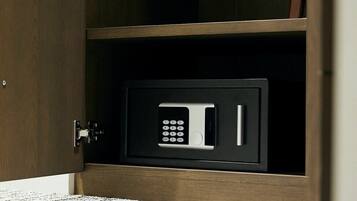 A microwave in a cabinet with a keypad.