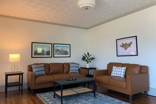 Spacious, stylish living room with all new furnishings, lighting, and decor.
