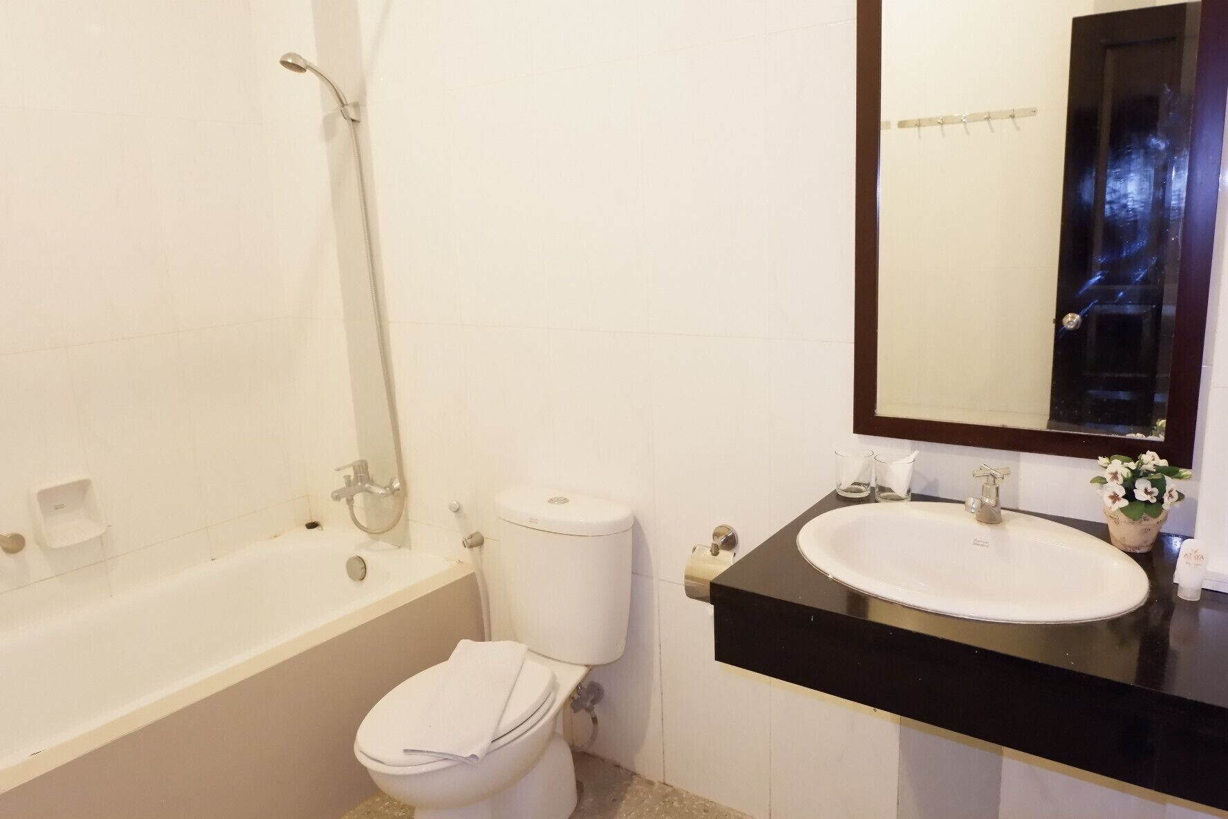 A bathroom with a bathtub, toilet, and sink.
