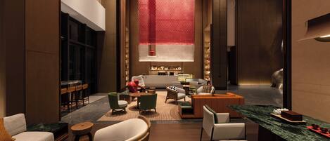 A modern hotel lobby with a seating area, a reception desk, and a large window with a red curtain.