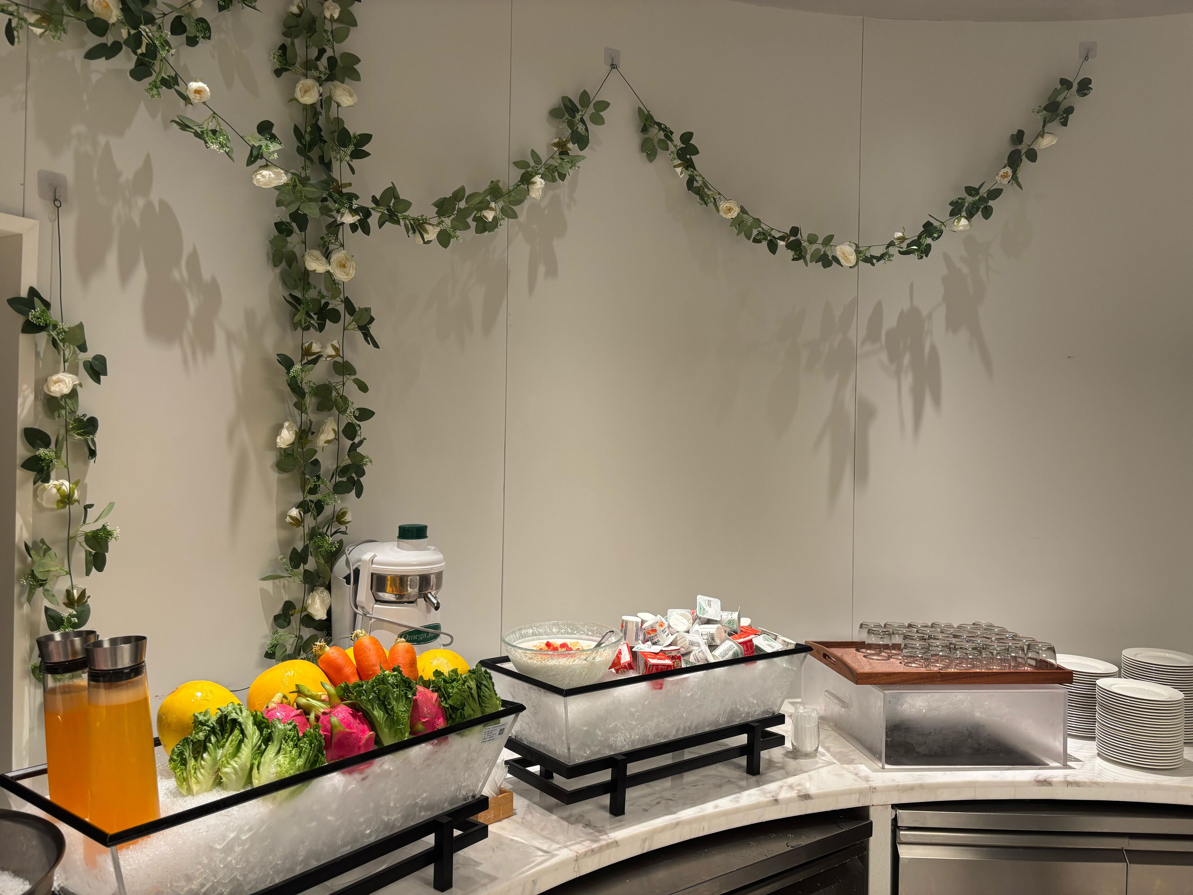 Un ricco buffet con diversi cibi e una ghirlanda floreale decorativa.