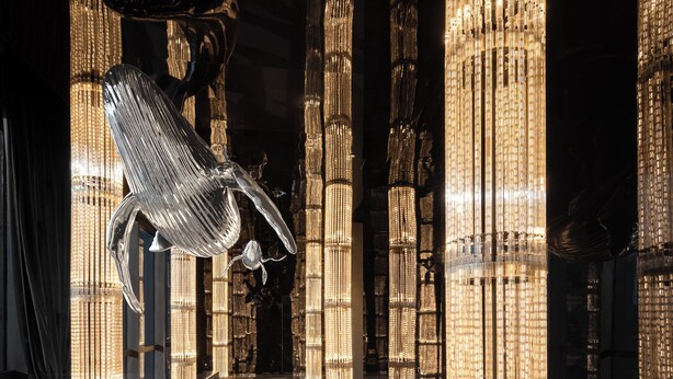 A modern interior with reflective floors and tall, illuminated columns. - Beijing Dongba Wanda Moments hotel (Beijing)