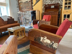 A cozy living room with a sofa, armchair, and a small table.