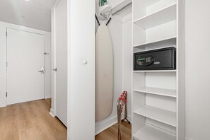 A room with a white door, a white shelf unit, and a white radiator. - Lovely Studio with Amazing Views (Hallandale Beach)