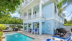 A two-story house with a swimming pool, outdoor seating, and a barbecue area. - Steps to Beach, Heated Pool, Elevator, Game Room (St. Augustine Beach)