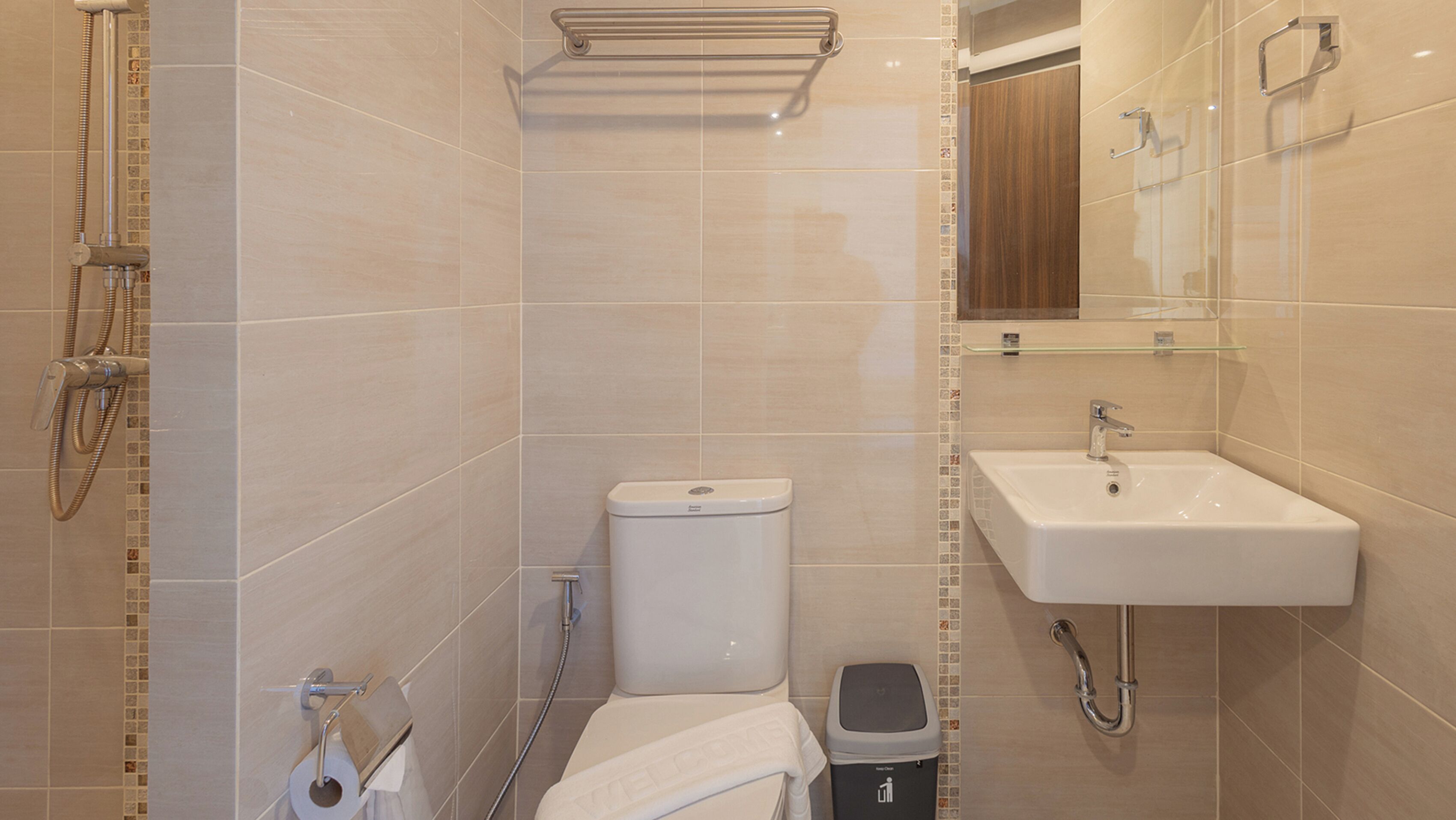 A modern bathroom with a toilet, bidet, and sink.