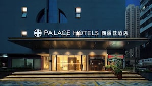 The exterior of Palace Hotels with a modern facade, a visible entrance, and a Bobby's Coffee shop adjacent to the entrance. - Palace Hotel Shenzhen Luohukou (Shenzhen)