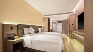 A modern hotel room with a large bed, bedside tables, a TV, and a shower area. - Palace Hotel Shenzhen Luohukou (Shenzhen)