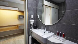 A modern bathroom with a large mirror, a sink, and a hairdryer. - QQ Hotel Rooms Damansara Perdana (Petaling Jaya)