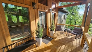 A wooden deck with a bench, two potted plants, and a table with chairs. - Luxe Cabin, View, 4 Bedrooms, Hot Tub, 3 Kings, Private, 8 min to DT BR (Blue Ridge)