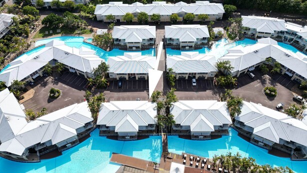 A resort with multiple swimming pools, arranged in a symmetrical layout with connected walkways. - Pacific Blue Unit 175 Dual Swim Up B (Salamander Bay)