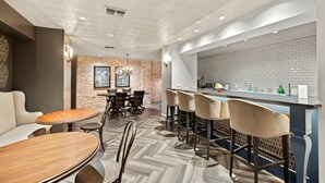 A modern interior with a bar area, seating, and a fireplace.